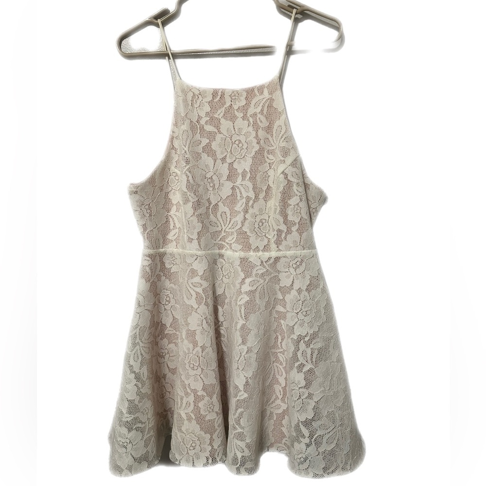 Adorable high neck white lace mini dress with nude underlay.